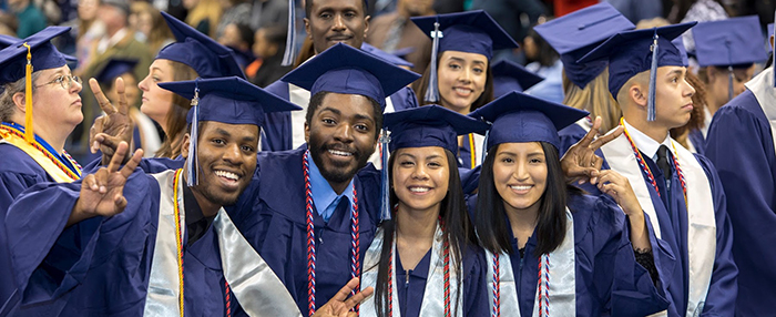 TCC Grads smiling at grad ceramony