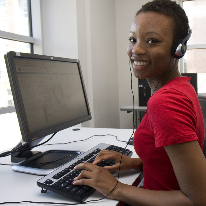 african american female student learning computer code in class