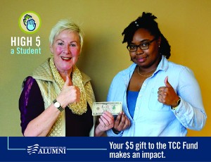 TCC faculty with student holding 5 dollar bill