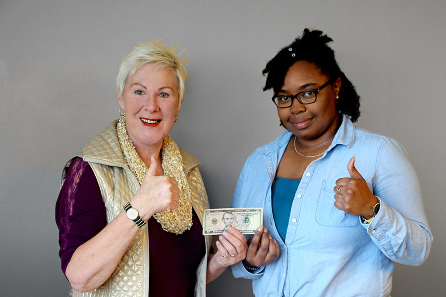 TCC faculty with student holding 5 dollar bill